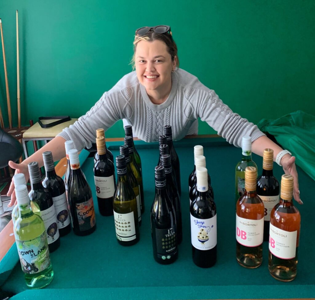 Second prize winner, Christina Jolley, showing her mixed dozen bottles of De Bortoli premium wines.