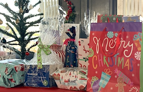 Image of assorted Christmas presents on a table ready for raffle.